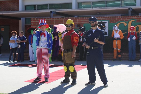 Students Jack Capell, Alexander Jasso-Prieto, and Joshua Ahlers posing for their winners photo in their Halloween costumes.
