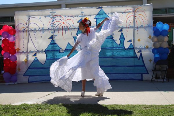 Junior Charlotte Fernandez Walker performs a traditional dance from Veracruz region of Mexico under the song of La Morena during the Fally Rally.