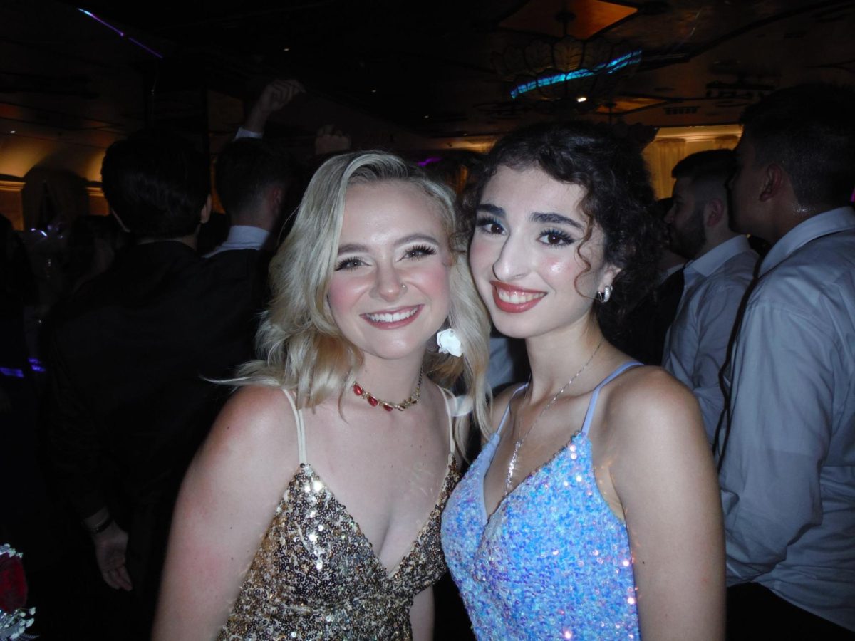 Seniors Cira Teeters and Malvina Karapetyan take a picture on the dance floor at Prom. 
