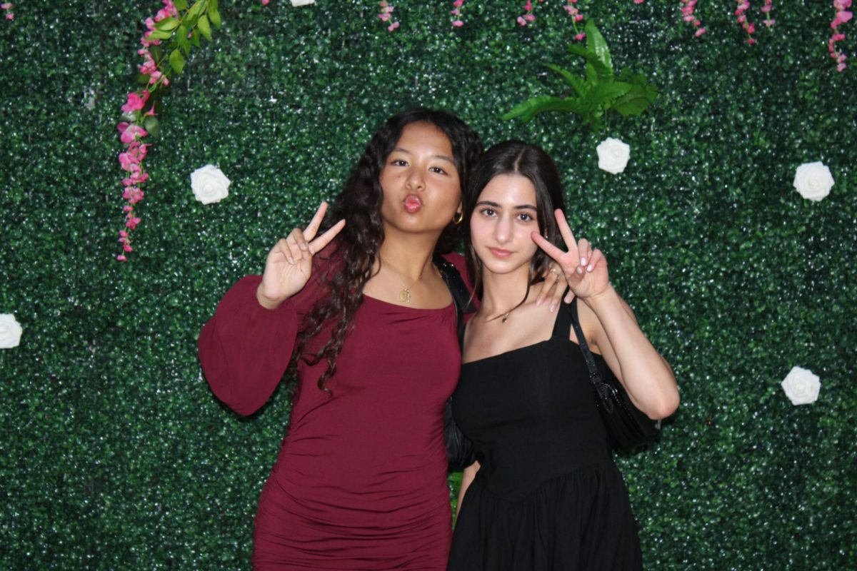 Juniors Sheenamarie Tanghal and Marina Davtyan posing for a picture in front of the bush-like background. 