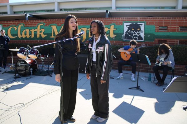 Juniors Elva Aghajanyan and Savannah Newman perform as vocalists in the Jazz Band, concentrating on the song's specific track.
