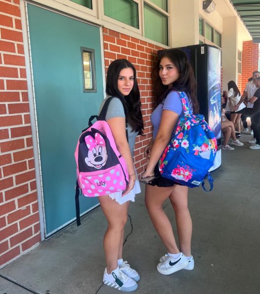 Seniors Aleen Yadegarian and Lily Tanossian with their Minnie Mouse and Alice in Wonderland backpacks.
