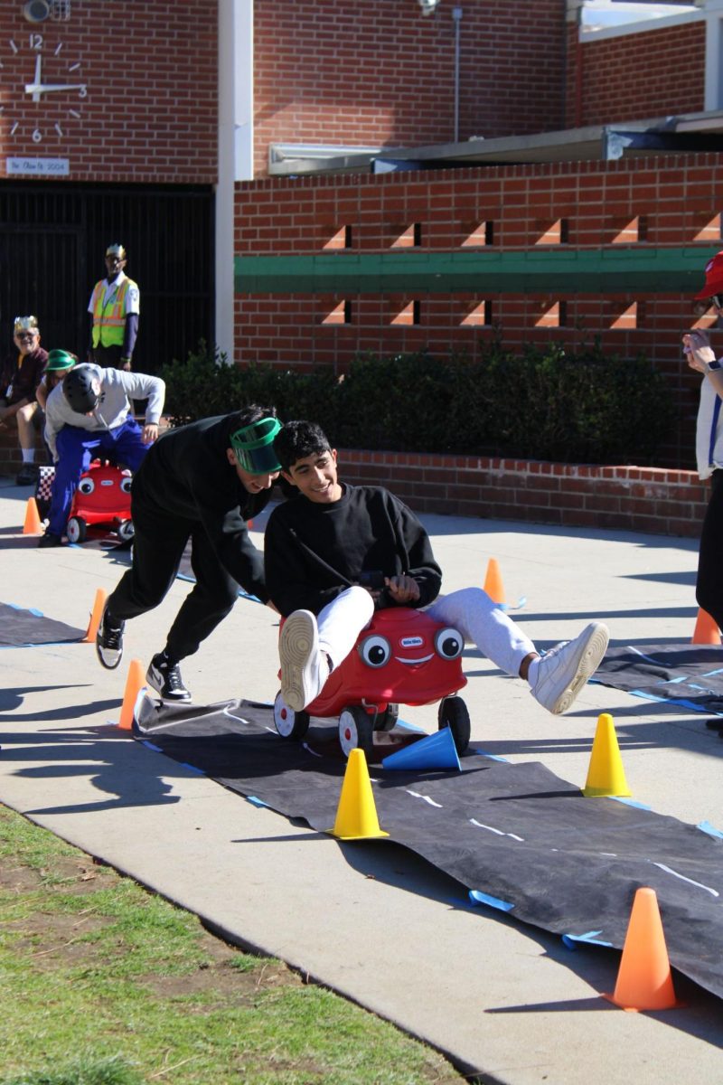 Sophomore Vahe Hayrapetian races through the track with determination and laughter while getting pushed in the cart by junior Arthur Ayvasyan during the thrilling Mario and Luigi’s Race! 