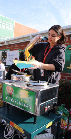 Senior Lia Khodaverdi is serving nachos for three tickets each.