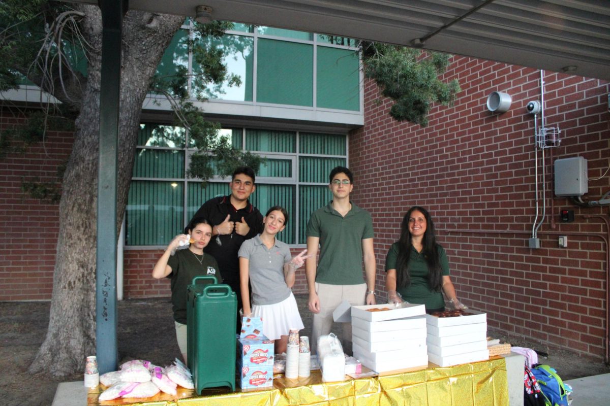 ASB helping out by passing out Donuts.