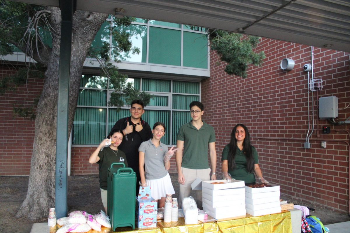 ASB helping out by passing out Donuts.