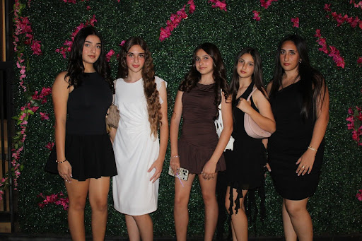 Freshmen Emma Martirosyan, Eva Hovsepyan, Angela Zakaryan, Yelena Martirosyan, Maria Perikhanyan, and Emmy Ghumashyan pose in front of the floral wall prepared by ASB.