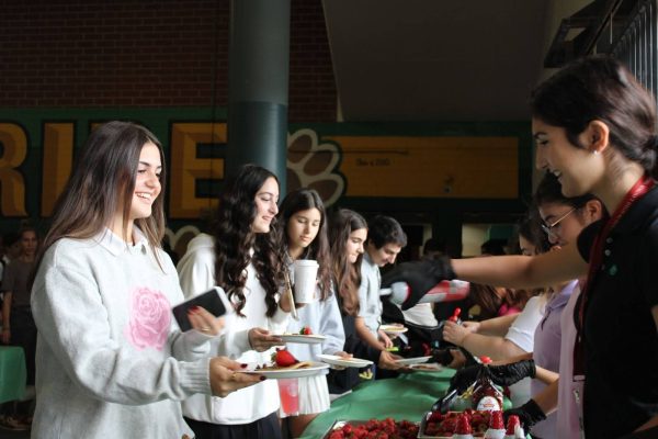 Freshmen Tatiana Karamanian, Tina Sarkisyan and Nicole Voskanyan get toppings for their pancakes.