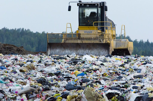 Landfills piling up with trash and clothing due to overconsumption.